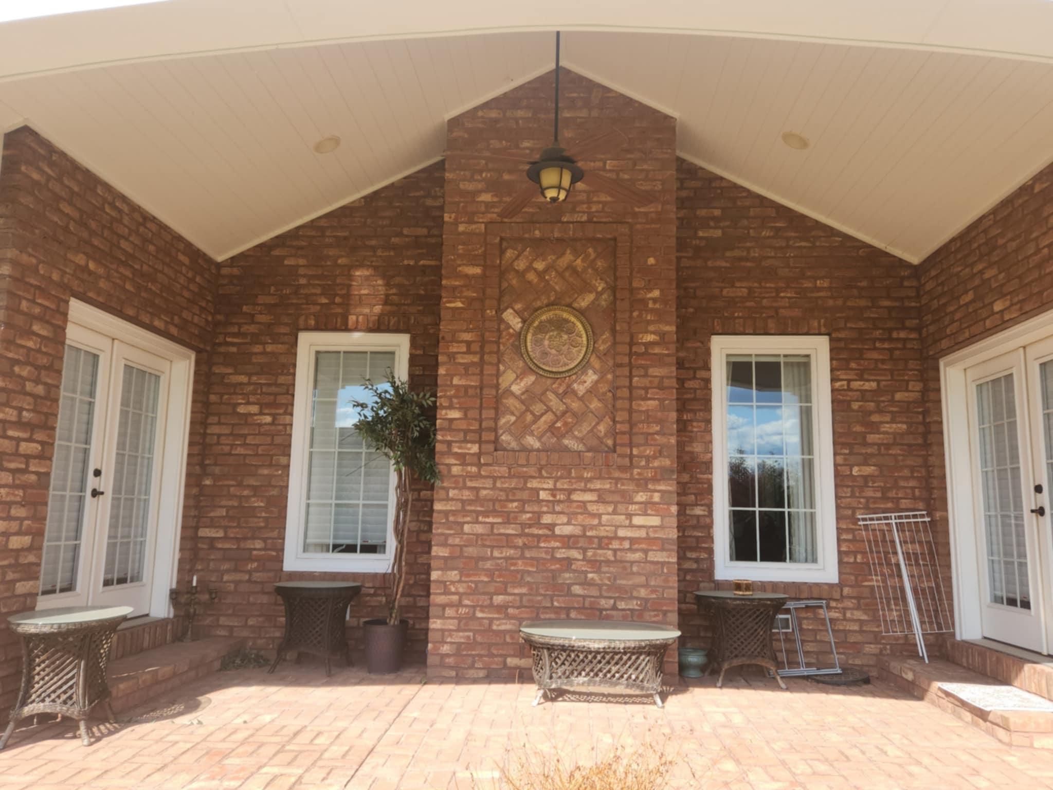 Custom brick patio under construction featuring a central herringbone pattern by Rhinesmith Masonry