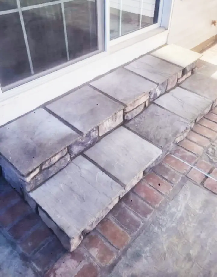 Custom entryway stone steps featuring a beautiful combination of natural stone and brick by Rhinesmith Masonry