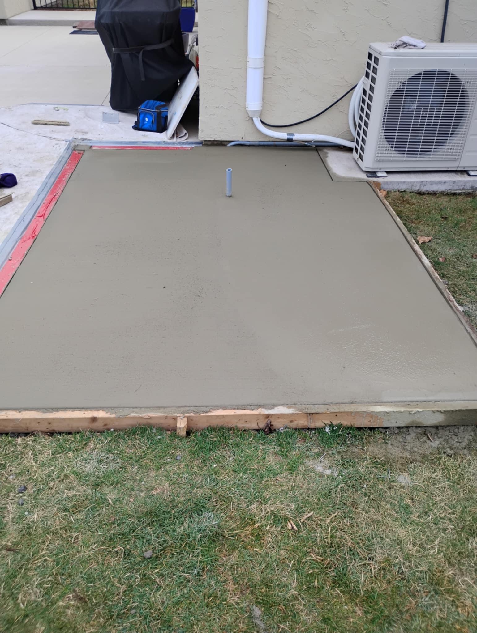 Precisely poured concrete hot tub pad with smooth finish and level surface by Rhinesmith Masonry