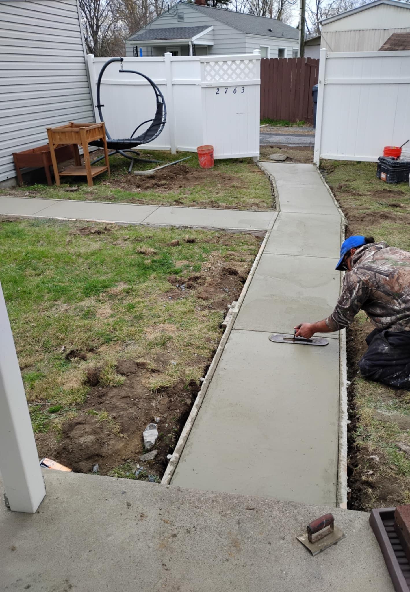 Newly poured concrete sidewalk with clean lines and precision finishing by Rhinesmith Masonry