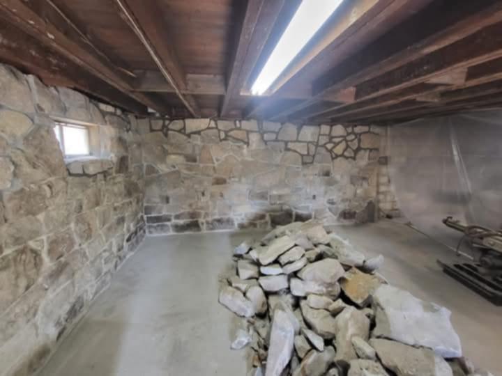 Interior stone wall under construction by Rhinesmith Masonry
